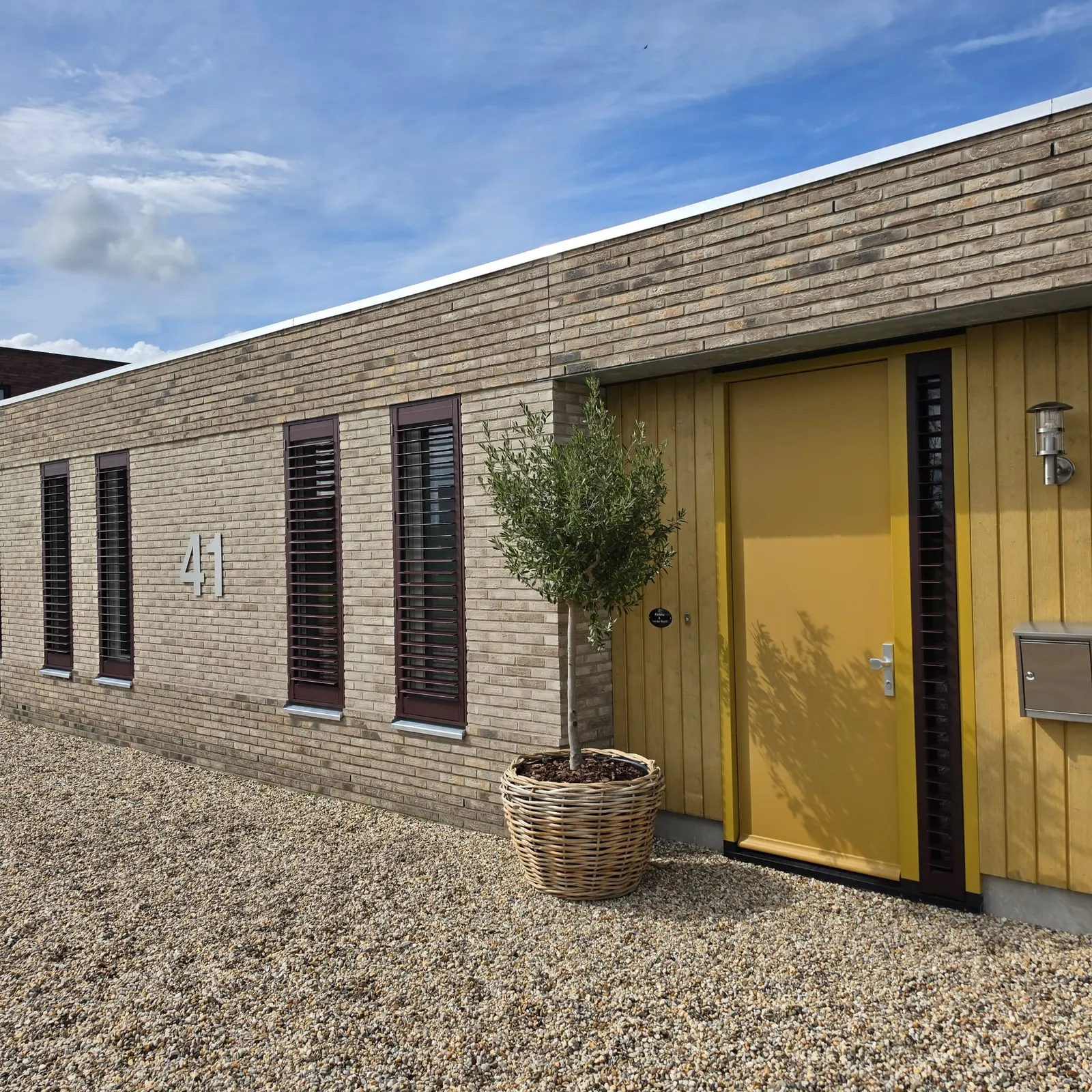 Matte black aluminium shutters on a timber patio structure