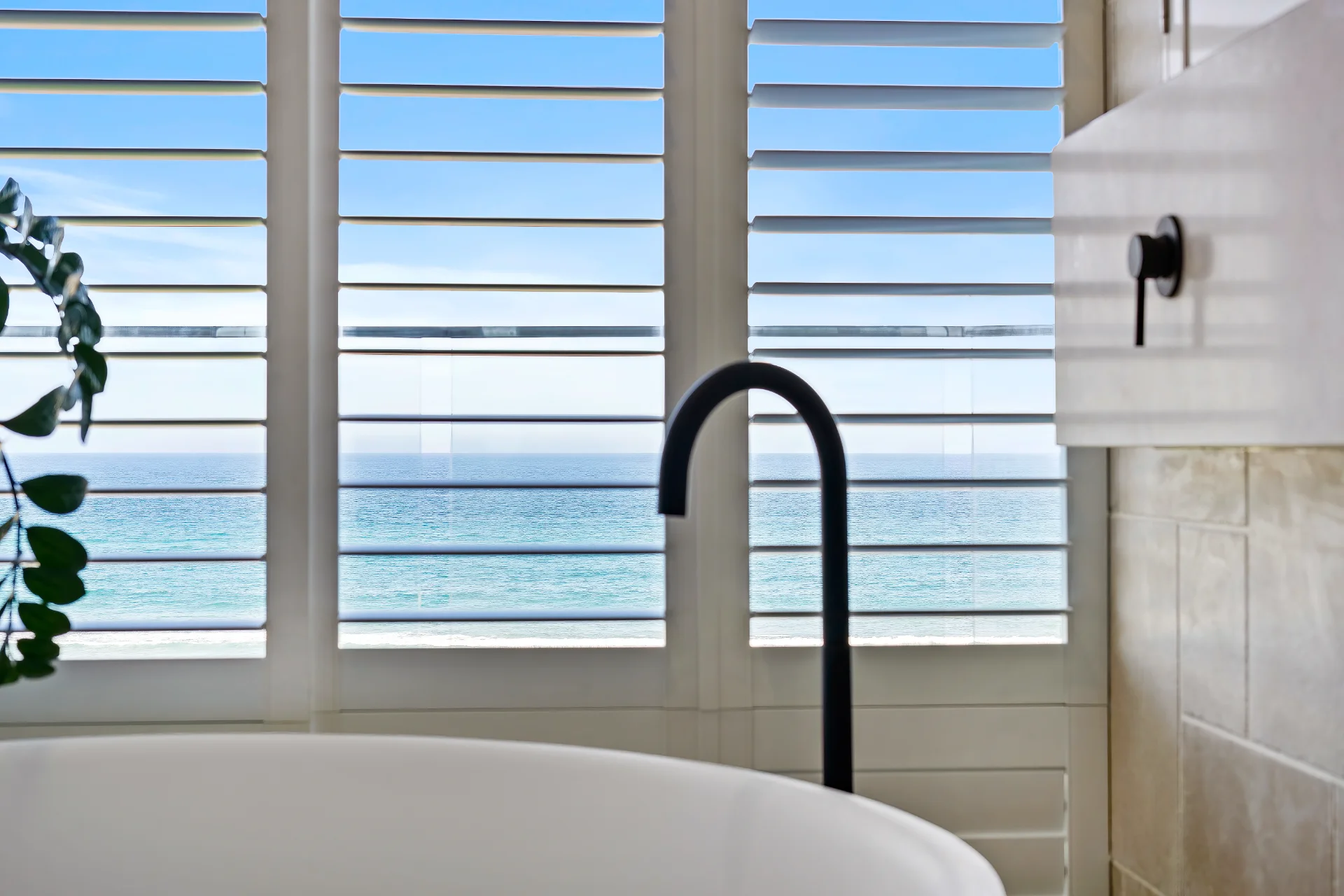 Sliding plantation shutters in a Miami Beach bathroom