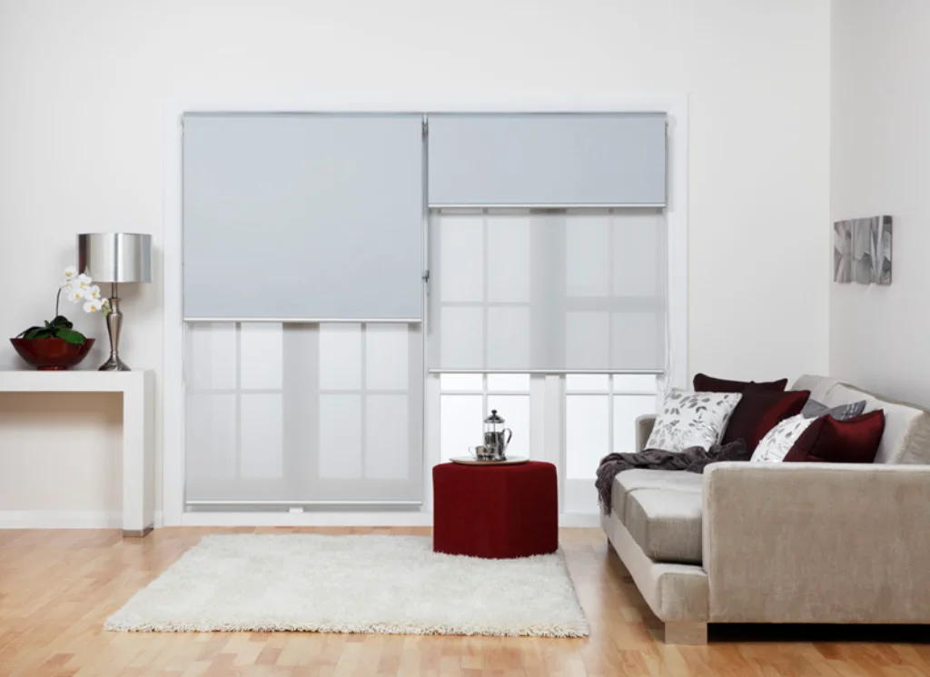 Dual roller blinds with blockout and sheer layers on a large living room window - Brisbane home